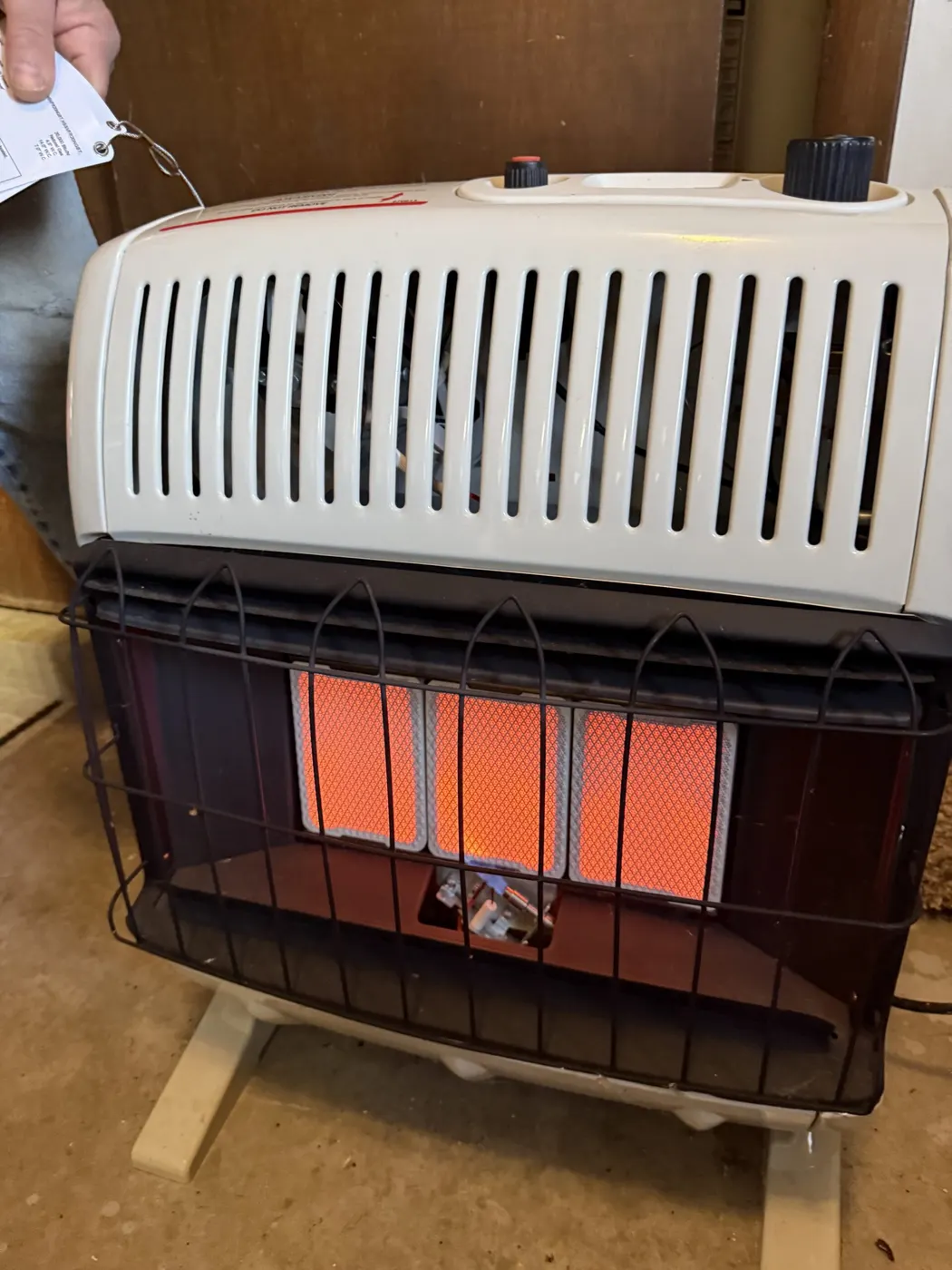 A gas wall heater glowing orange after installation